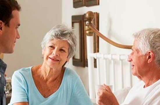 Doctor On Home Visit Discussing Health Of Senior Male Patient