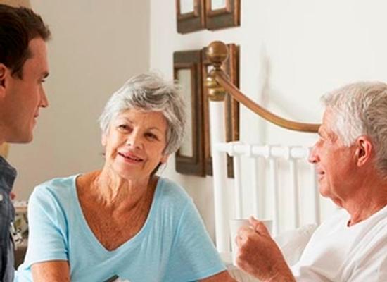 Doctor On Home Visit Discussing Health Of Senior Male Patient